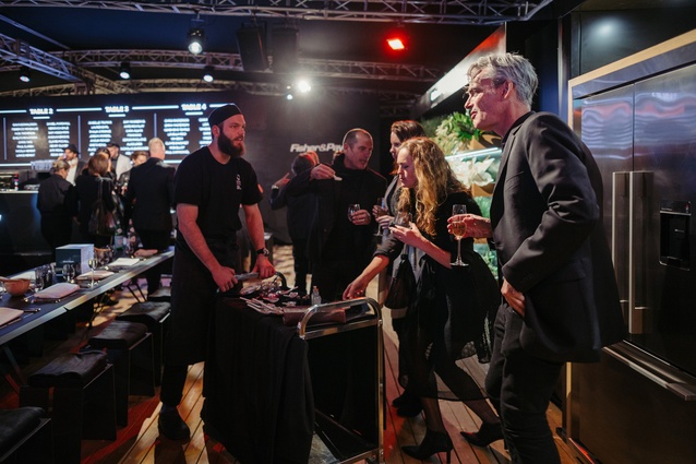 Guests, including architects Lance and Nicola Herbst and Daniel Marshall, sample food and wine.