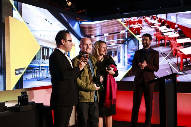 Scott Compton and Thalea Carruthers of WAM receiving trophy from Federico Monsalve, editor <em>Interior</em>.